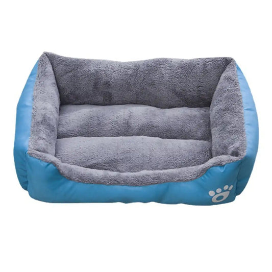 blue rectangular dog bed with plush interior and paw print logo on the front